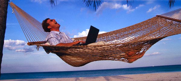 man-laughing-hammock-sea-laptop.jpg