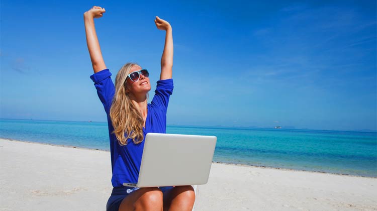 woman-with-laptop-on-beach-earning-passive-income