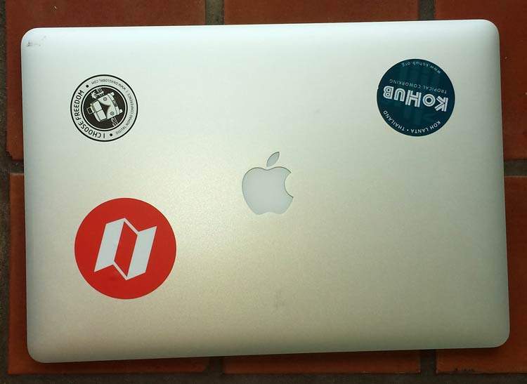 macbook pro with digital nomad stickers